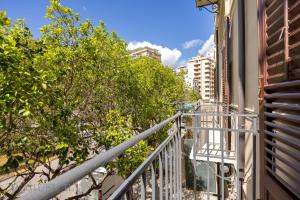 a balcony of a building with trees and buildings at Real Tenuta Apartments By Domus Sicily in Palermo