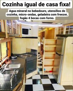 a kitchen with a black and white checkered floor at Motorhome Mundo em Família in São Roque