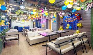 a restaurant with tables and chairs and balloons at Treebo Shakuntalam, Near Lucknow Airport in Lucknow