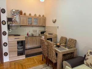 a kitchen with a table and a dining room at Apartment 50 in Podgorica