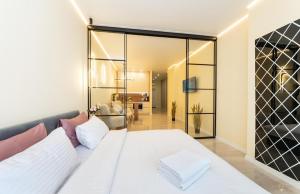 a bedroom with a white bed with pillows at Comfort Apartment near Minskaya metro station and DreamTown in Kyiv
