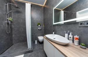 a bathroom with a white sink and a shower at Comfort Apartment near Minskaya metro station and DreamTown in Kyiv +20 photos