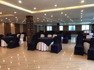 a banquet hall with blue and white tables and chairs at Nepalirika Hotel Damak in Pānigata +18 photos