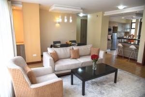 a living room with a couch and a table at Fedha Residences by Trianum in Nairobi