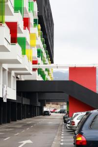 a building with cars parked in a parking lot at Makovi Flat in Zenica