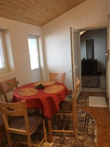 una sala da pranzo con tavolo e sedie rossi di Апартамент Плевен a Pleven