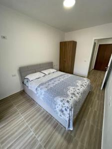 a bedroom with a large bed in a room at Shengjin Apartment in Lezhë +10 photos
