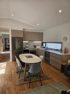 a kitchen and living room with a table and chairs at Winterlude Cottage in Orange