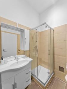 a bathroom with a shower and a sink and a toilet at Brodschildstraße apartment in Stockerau
