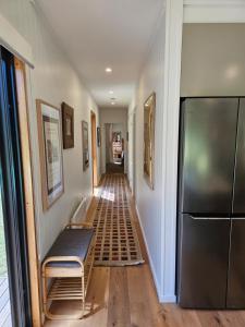 a hallway with a couch and a refrigerator at Winterlude Cottage in Orange