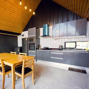 a large kitchen with a wooden table and chairs at NP Pool Villa Hua Hin in Hua Hin