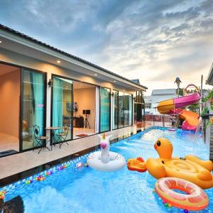 a swimming pool with a slide and a inflatable at NP Pool Villa Hua Hin in Hua Hin