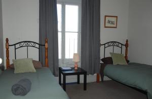 1 Schlafzimmer mit 2 Betten und einem Fenster in der Unterkunft THE FED AND BED TEMORA in Temora