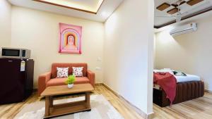 a living room with a couch and a bed at ZEN Medicity - Hotel & Serviced Apartments Gurgaon in Gurgaon