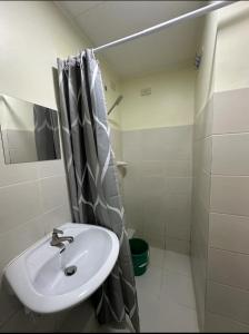 a bathroom with a sink and a shower at Sanremo Oasis, City de Mare in Cebu City
