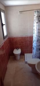 a bathroom with a toilet and a sink and a shower curtain at Apartamet Benidorm in Benidorm