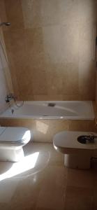 a bathroom with a white tub and a toilet at Apartamet Benidorm in Benidorm