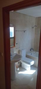 a bathroom with a toilet and a sink and a tub at Apartamet Benidorm in Benidorm