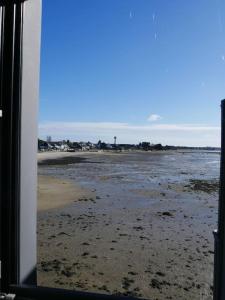 a view of the beach from the window of a bus at ARSAV Vue Mer et Plage in Port-Louis