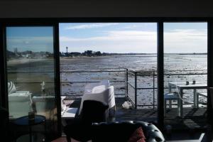 a room with a view of the ocean from a window at ARSAV Vue Mer et Plage in Port-Louis +22 photos