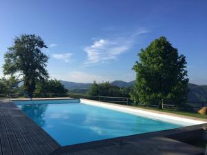 a swimming pool with mountains in the background at Na Skaluc - Country estate & Glamping in Trobni Dol