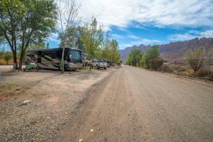a dirt road with cars parked on the side of it at Moab RV Resort RV Fully Setup OK41 in Moab