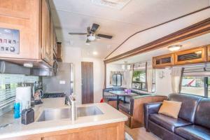 an rv kitchen with a sink and a couch at Moab RV Resort RV Fully Setup OK41 in Moab