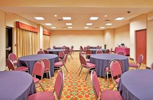 a conference room with blue tables and chairs at Holiday Inn Express Hotel & Suites Port Richey by IHG in Port Richey +33 photos