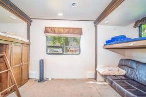 a small room with a couch and a window at Moab RV Resort RV Fully Setup OK41 in Moab