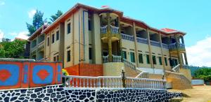 a large building with stairs in front of it at Mont Carmel Hotel in Gisenyi