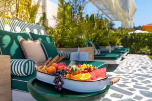 a bowl of fruit sitting on a table on a patio at Voger Alaçatı Prive in Cesme