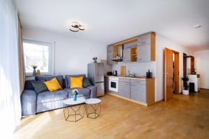 a living room with a couch and a kitchen at Kim Fewo 3 in Emmendingen