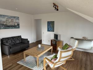 a living room with a couch and a table at Jugendherberge Tönning in Tönning