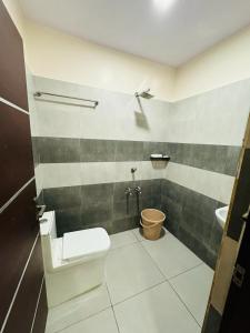 a bathroom with a toilet and a sink at Royal Plaza City in Kozhikode