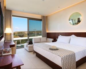 a hotel room with a bed and a large window at Voger Alaçatı Prive in Cesme +128 photos