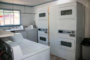 a kitchen with white appliances and a window at Moab RV Resort Glamping Setup Tent in RV Park #2 OK-T2 in Moab