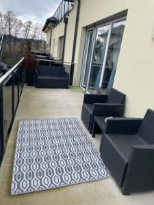 a patio with two chairs and a rug at Sorinas Unterkunft WB16 Top 13 