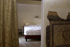 a bedroom with a bed in a room with a window at Residenza Madonna Verona in Verona