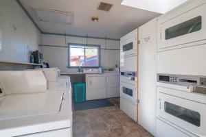 a kitchen with white appliances and a window at Moab RV Resort Glamping Setup Tent OK-T3 in Moab