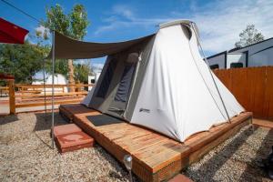 a tent sitting on top of a wooden platform at Moab RV Resort Glamping Setup Tent OK-T3 in Moab