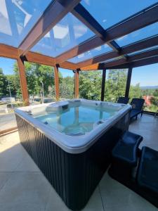 a large jacuzzi tub on a patio at Karpacki & SPA adults only in Karpacz