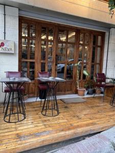 two tables and chairs in front of a building at Volga Rika Hotel in Istanbul