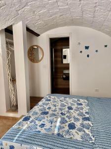 Casa Raffaella في مونوبولي: غرفة نوم بسرير لحاف ازرق وبيض