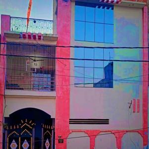 a building with a painting on the side of it at Atithi Dev Guest House in Ayodhya