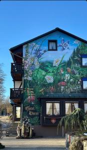 a building with a mural on the side of it at Boutique Hotel Dorer in Schonwald im Schwarzwald +116 photos
