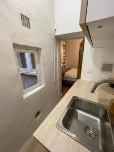 a kitchen with a sink and a window at Les Balcons de Guignol in Lyon