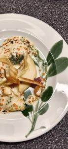 ein weißer Teller mit Essen auf einem Tisch in der Unterkunft Boutique Hotel Dorer in Schönwald + 116 Fotos