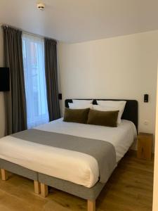 Postel nebo postele na pokoji v ubytování Appart Hôtel Victoria
