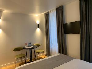 Postel nebo postele na pokoji v ubytování Appart Hôtel Victoria