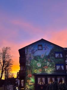 a building with a painting on the side of it at Boutique Hotel Dorer in Schonwald im Schwarzwald